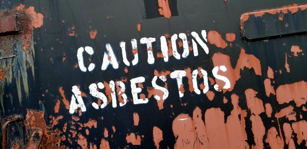 This sign says, "Caution Asbestos" and it may be placed in Utah.